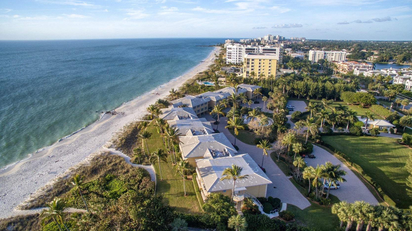 Waterfront real estate along a white sand beach in Florida